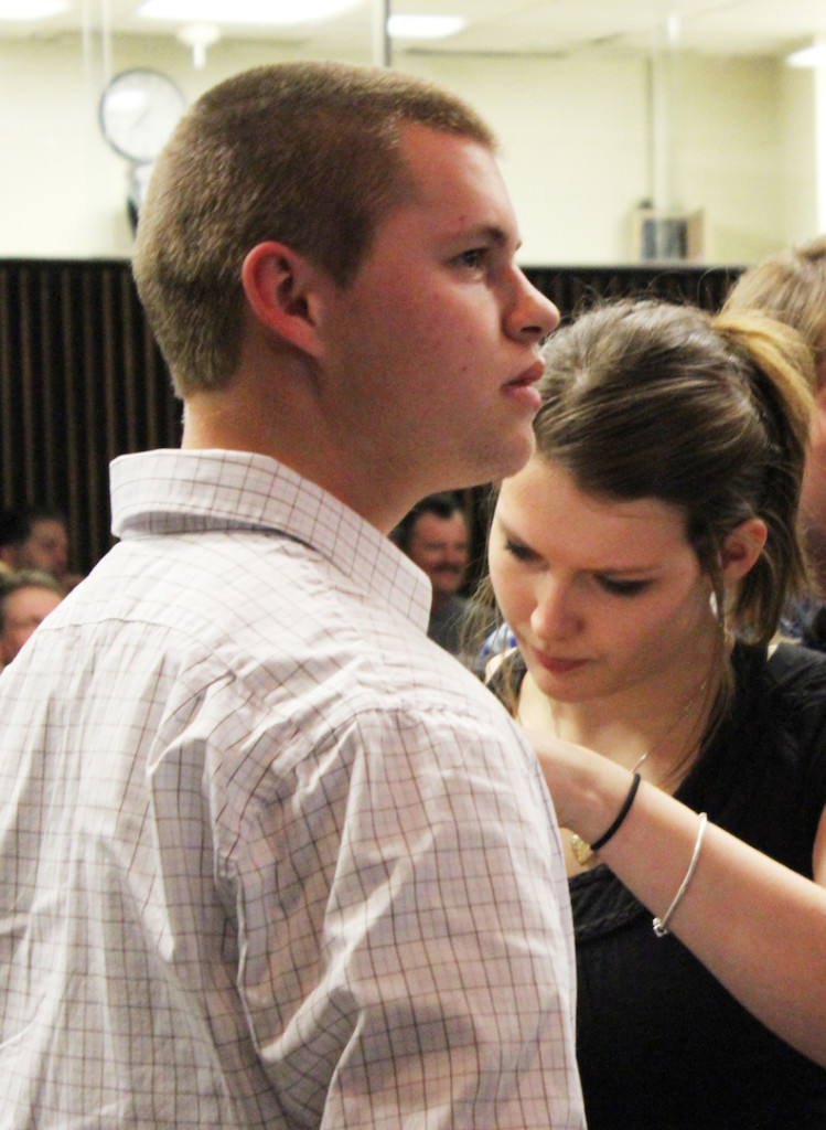 Albert Pool has his new SKD membership pin fastened by fellow inductee Rebecca Williams. LAUREN MARRETT | THE HARBINGER