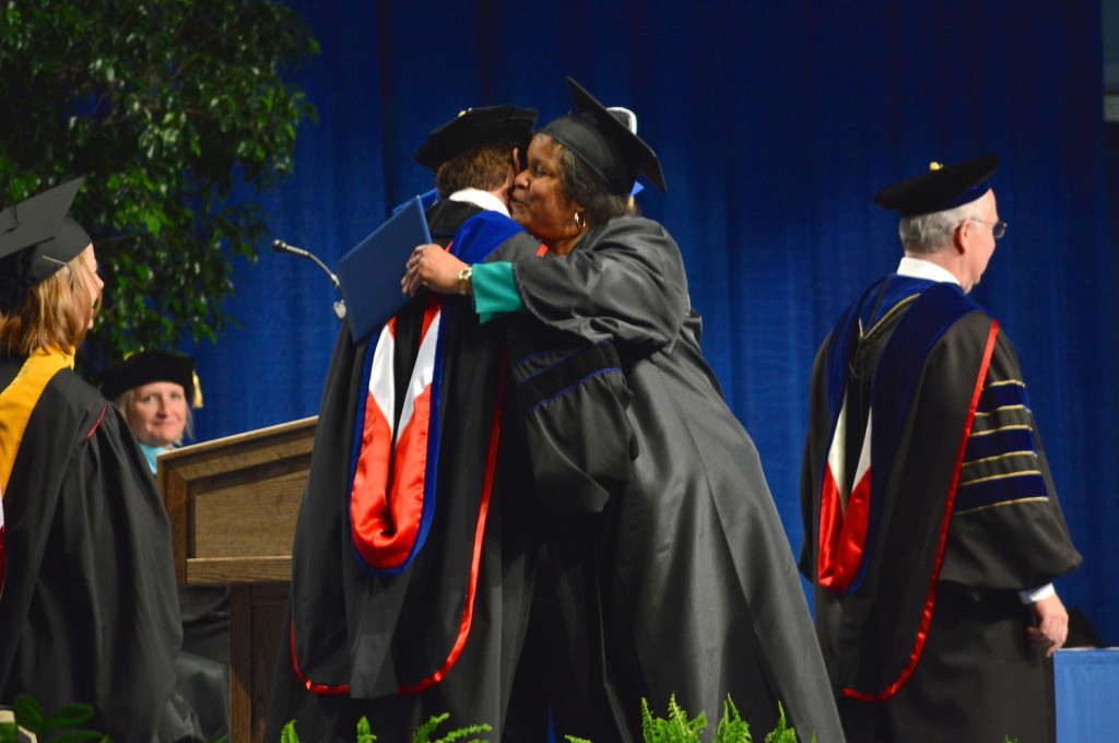 Graduate Michele Donnan give ICC President John Erwin a hug and kiss after she was handed her degree. REID|HARBINGER