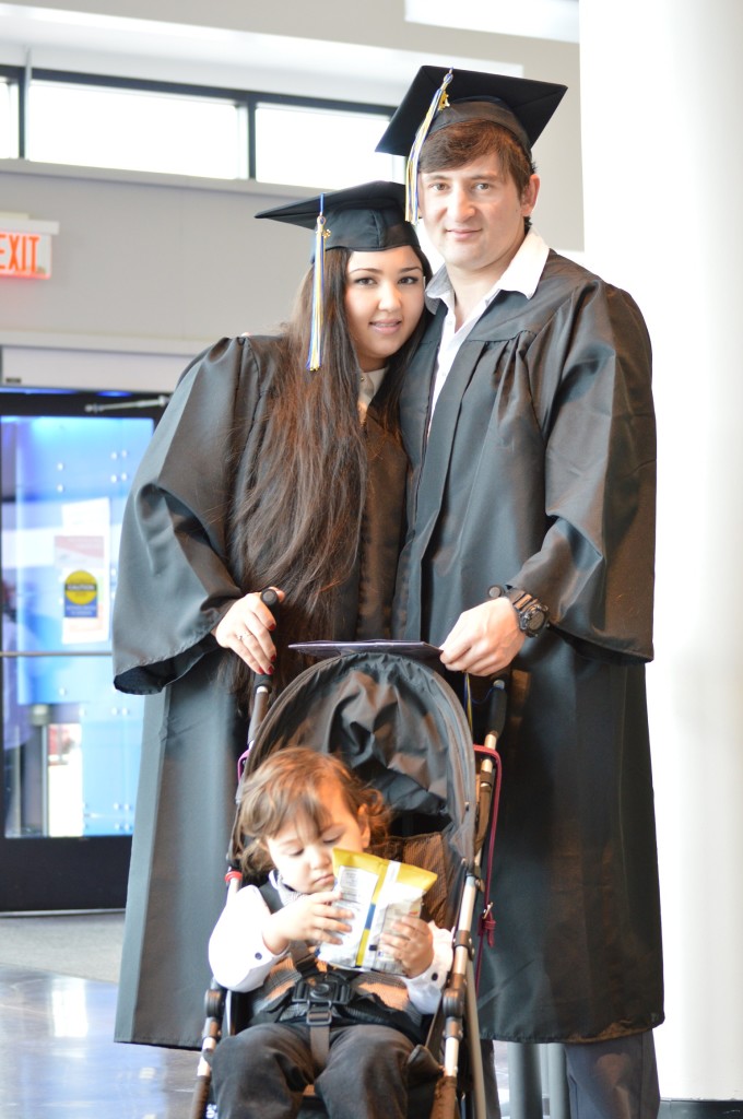 Couple Nigina Sultanova, left, and Rustam Ulmasov both graduated in the presence of their son Usmon. REID|HARBINGER
