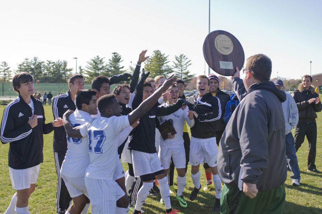 The team rushes to meet their trophy earned by taking regionals. Photo courtesy of ILLINOIS CENTRAL COLLEGE.